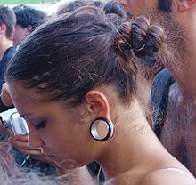 Young woman with stretched ear piercing.jpg